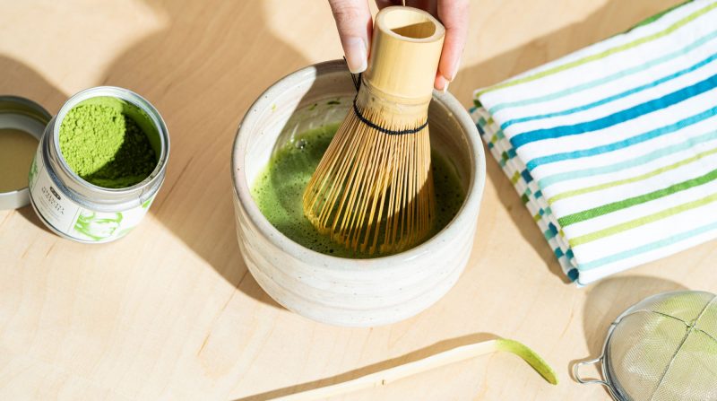 beat matcha with water using chasen with energetic movements